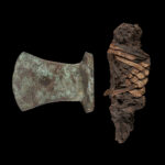 EGYPTIAN BRONZE AXE WITH FRAGMENT OF SHAFT